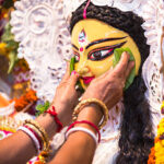 An Indian Deity : Goddess Durga during Durga Puja festival. Ladies bidding adieu to the mother Goddess on the last day of the festival , before immersion in a river.  Durga worship is a yearly event and these deities are created every year and immersed in a river every year after the completion of the 5-day event. The idol is not copyright protected.