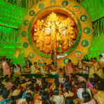 Kolkata, India  - October 2, 2014: People enjoying inside Durga Puja Pandal (decorated temporary temple). Biggest religious festival of Hinduism and local Bengali community, documentary editorial.